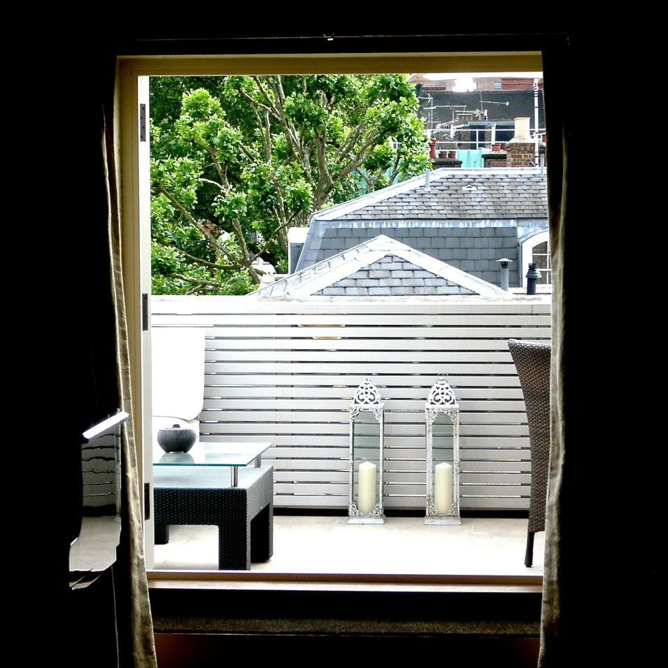 I really enjoy a challenge & this tiny terrace in London was quite a challenge. I used mirrors behind timber strips to bring the space to life & reflect light - particularly at night when it looks like a very smart jewel box