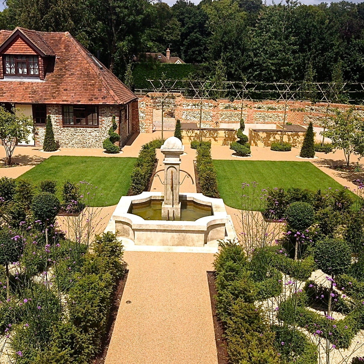 This is the lovely French style walled garden I designed for my clients near Henley on Thames. It has an original French stone fountain similar to those seen all over French public spaces