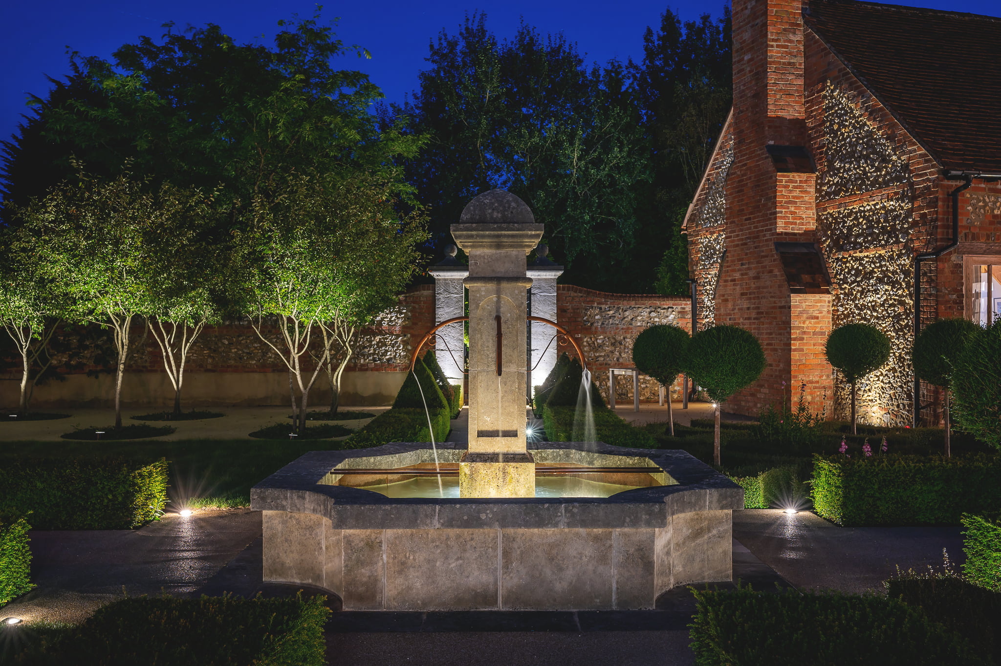 stone fountain in formal french style walled garden with parterre. Design by Jo Alderson Phillips www.joannealderson.com
