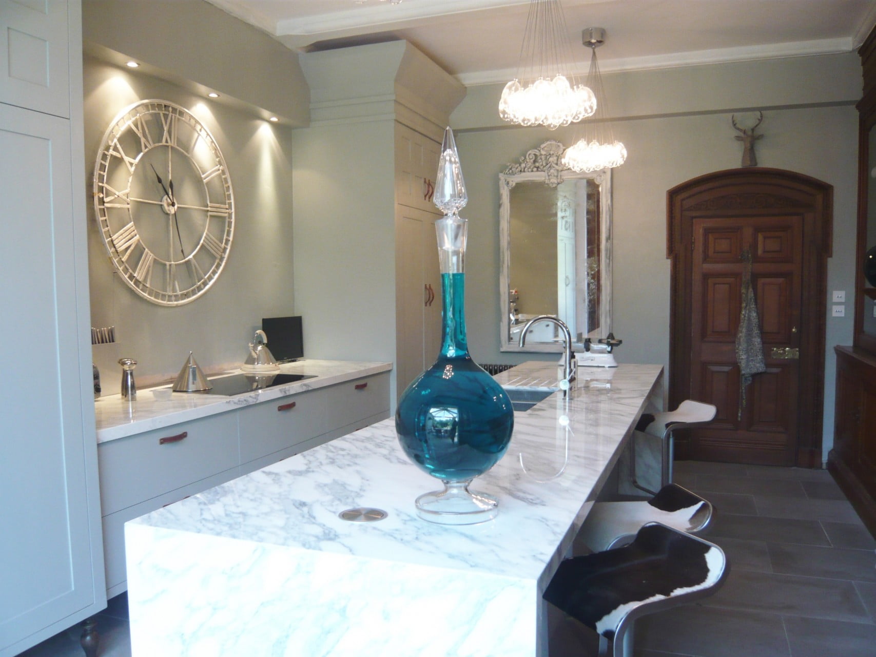 We redid the kitchen of our Victorian house & here it is now complete. We used marble & stone & clusters of globe lights . I don't just design gardens!