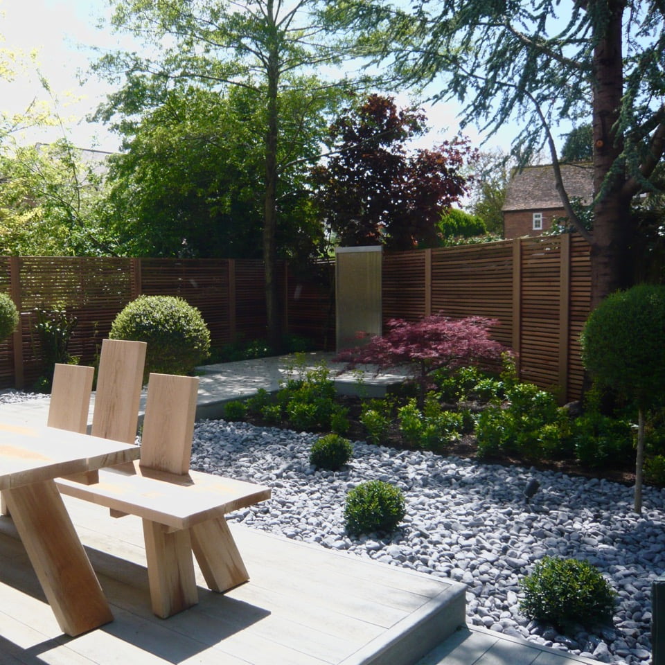 Pretty acers & boardwalk in this modern garden design with water feature & cedar strip fencing