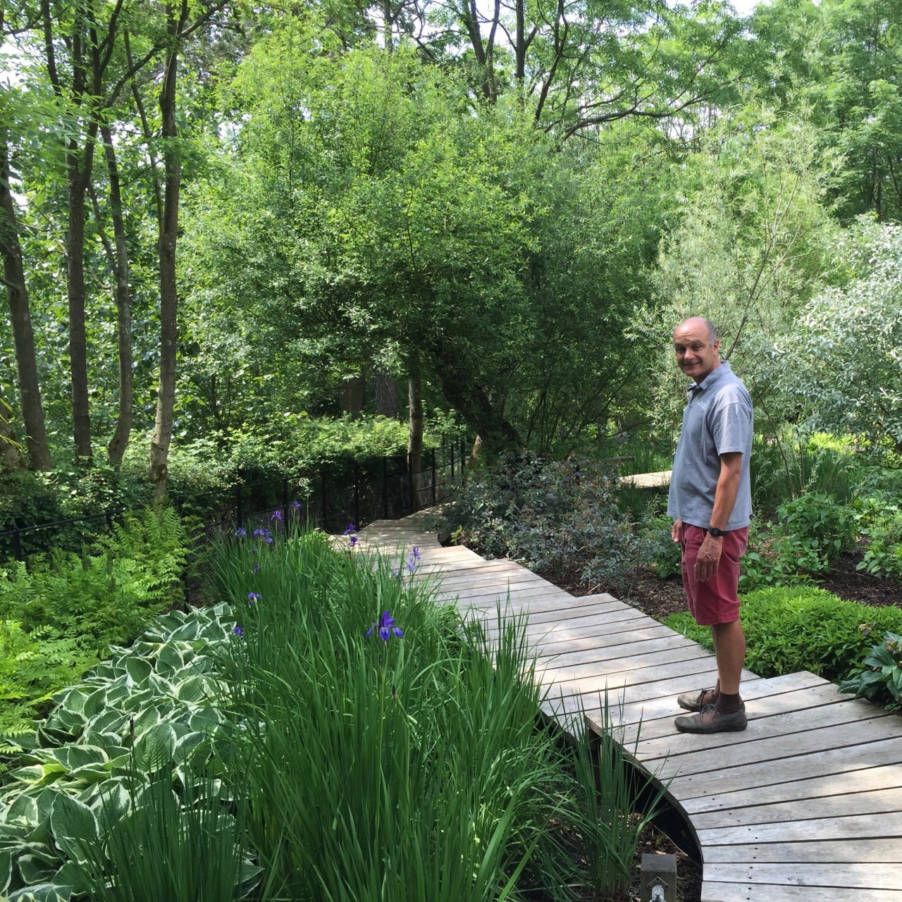 This is Rob Jones on the boardwalk I designed & he built over a bog garden for our client Jane