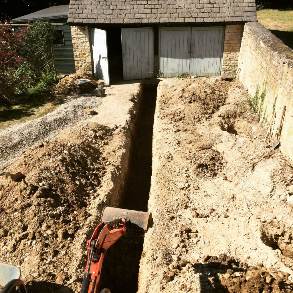 This trench marks the foundation line for the extension leading from our barn along this Cotswold wall & to what will become my  new studio