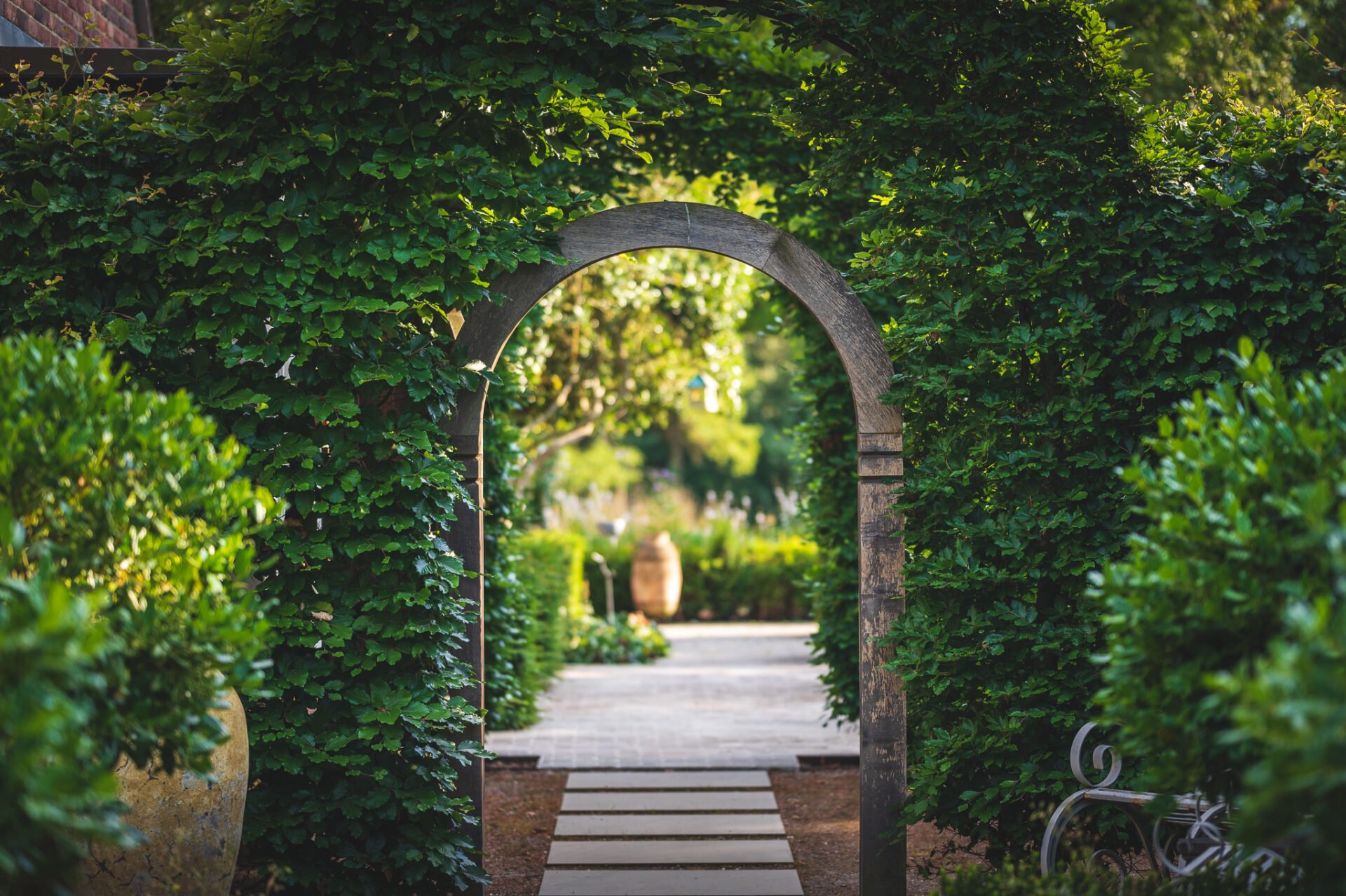 Bespoke arch in oak leading into the garden designed by Jo Alderson Phillips - www.joannealderson.com