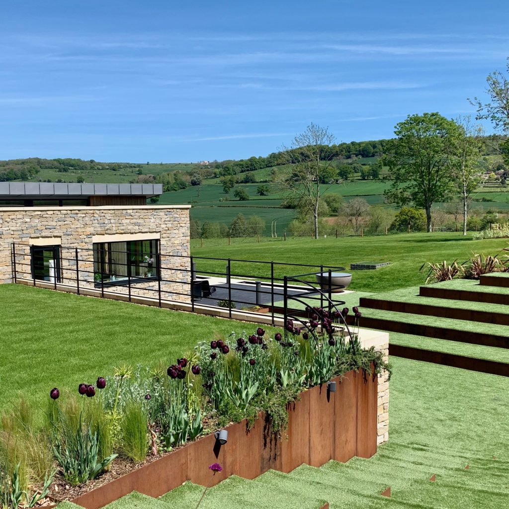 Corten steel suports adding architectural deail to this contemporary Cotswold garden